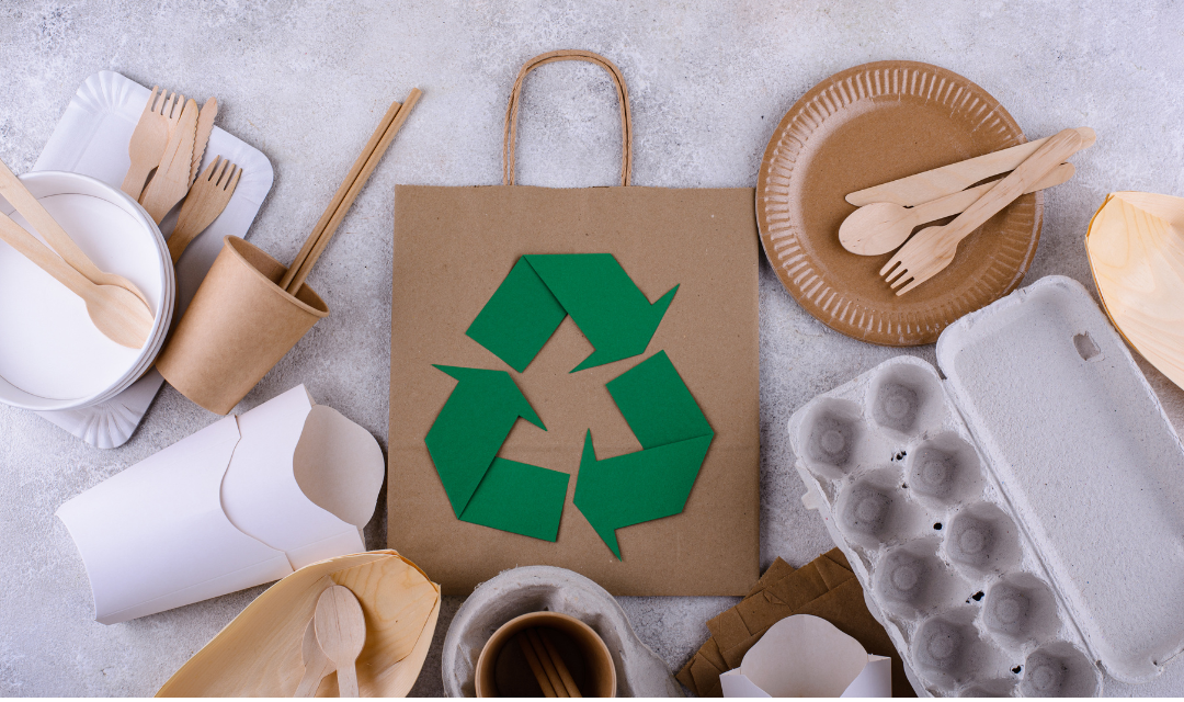 Eco-friendly packaging and utensils with a recycling symbol on a paper bag, symbolizing the successful SEO strategy for a company offering sustainable products, resulting in increased organic traffic, high-quality backlinks, improved search engine rankings, and a significant boost in online sales.