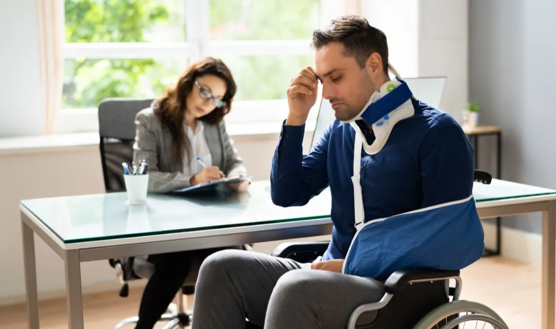 A man with a neck brace and arm sling consulting with a lawyer, representing a personal injury law firm's SEO strategy to improve online visibility, attract local clients, and increase organic traffic through targeted keywords and high-quality backlinks.