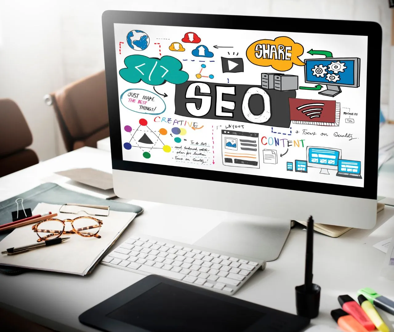 Desktop monitor displaying a colorful diagram with the word "SEO" surrounded by various icons and illustrations, representing the concept of real estate SEO strategies for improving visibility and generating qualified leads.